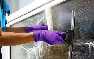 Person using squeegee o clean window
