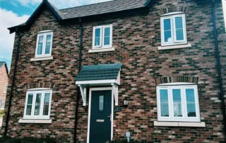 Clean uPVC windows on a traditional British brick house