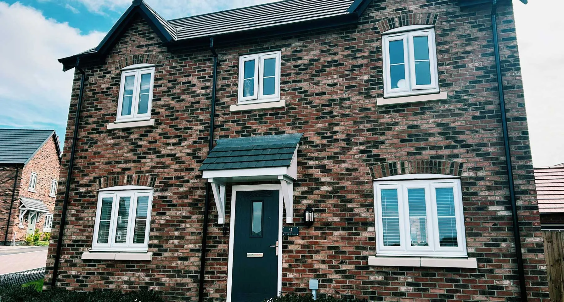Clean uPVC windows on a traditional British brick house